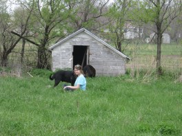 Katherine and Meeko in front of an old chicken house that will be a temporary dog house.